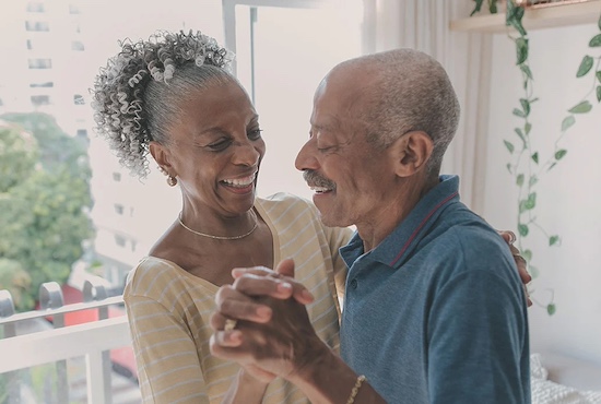 elderly couple dancing together and smiling